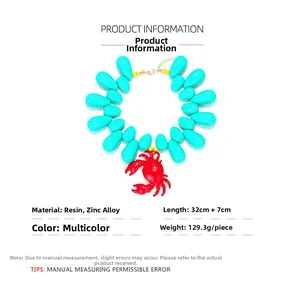 Detailed view of ocean style crab pendant with oversized turquoise resin waterdrop beads