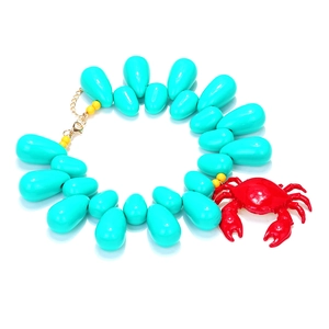 Summer ocean necklace featuring teal teardrop beads and a vibrant red crab pendant charm
