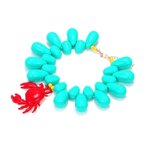 Handmade ocean style necklace featuring cyan teardrop beads and a red crab pendant