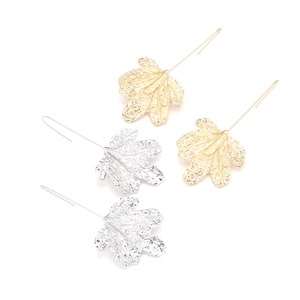 Detailed view of long leaf pendant earrings in textured gold and silver finishes