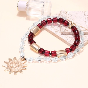 Bohemian double-layered beaded necklace with burgundy resin beads and golden sun pendant