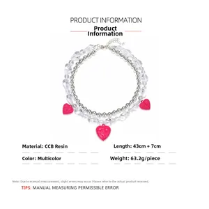 Detailed view of layered beaded necklace with pink heart pendants and resin candy beads