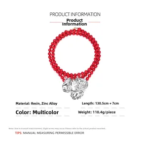 Detail view of a triple-layer red resin bead necklace with a large zinc alloy pendant