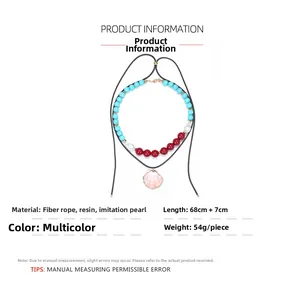 Detail of bohemian layered necklace with turquoise beads and pink scallop shell pendant