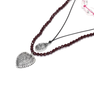 Layered bohemian necklace with red faceted beads and vintage silver heart pendant