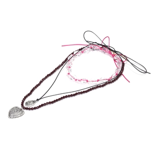 Boho layered necklace set with heart charms, red beads, and vintage silver pendants