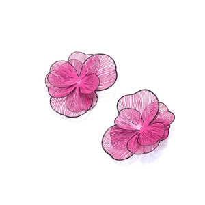 Macro detail of 3D layered pink floral earrings with textured openwork petals