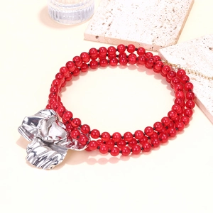 Handmade necklace with red beads and a bold silver 3D floral pendant in boho style