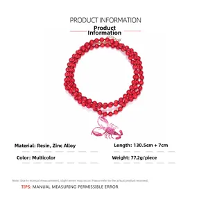 Detail of red beaded necklace with a pink UV lobster pendant and resin beads
