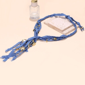 Long blue fabric necklace with golden geometric pendants in a luxury bohemian style