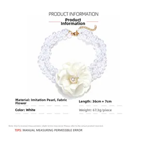 Detailed view of layered faux pearl necklace with large white fabric camellia flower