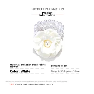 Detail shot of white fabric flower bracelet with imitation pearls showing 11cm length size