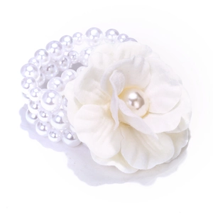 Bohemian multilayer pearl bead bracelet featuring a large white fabric flower ornament