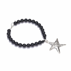 Detail of beaded necklace with silver starfish pendant and polished black beads