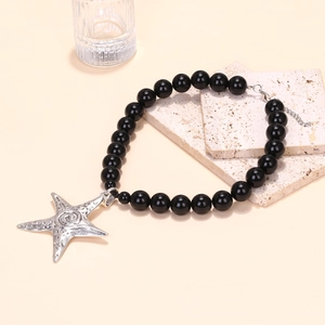 Handmade beaded necklace featuring black beads and vintage silver starfish pendant