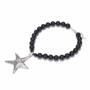Handmade black beaded necklace featuring a large silver starfish pendant with textured detail