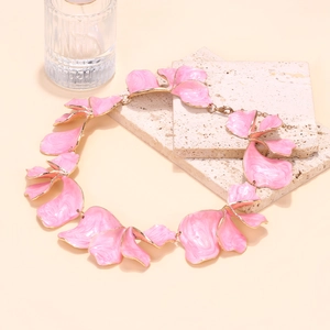 Close-up of pink enamel flower petals with gold edges on an adjustable necklace chain