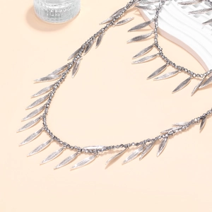 Multi-layer beaded necklace with silver leaf pendants in a minimalist bohemian style