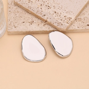 Detailed macro view of silver irregular oval earrings with a polished mirror finish