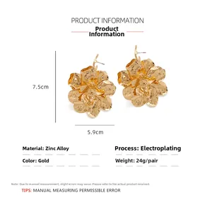 Detail view of large gold floral earrings with dimensions 7.5cm by 5.9cm in metal texture
