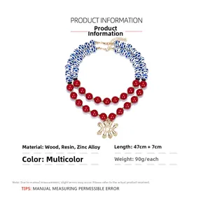 Detail of layered boho necklace with blue floral beads and golden sun eye pendant