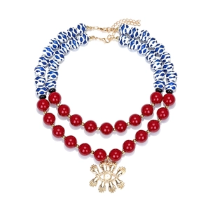 Layered beaded necklace with colorful beads and gold evil eye pendant on white backdrop