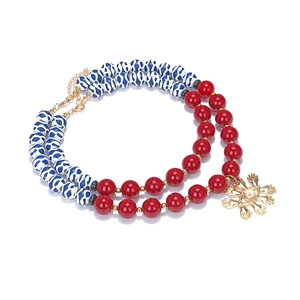Double-layered beaded necklace with colorful beads and gold evil eye palm pendant