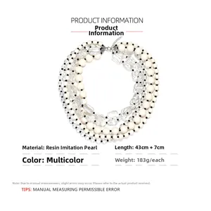 Detailed close-up of multilayer resin beads and faux pearls with silver lobster clasp