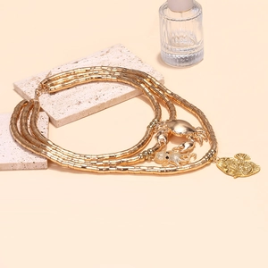Detailed close-up of bohemian layered necklace with golden crab and octopus charms