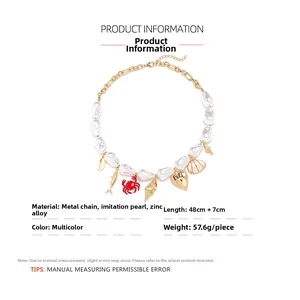 Detailed view of baroque pearl necklace with crab, shell, and heart pendant charms
