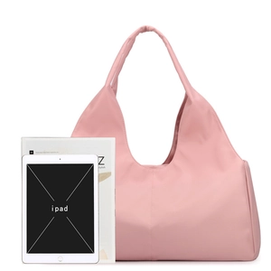Pink large capacity fitness bag with shoe compartment shown with iPad and magazine