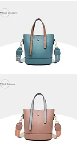 Detail view of two-tone PU leather bucket bags in blue and pink with wide patterned straps