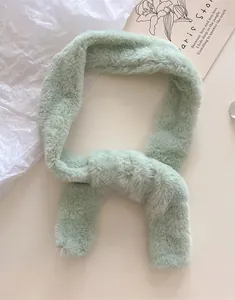 Close-up of soft mint green faux fur neck warmer with a plush and cozy texture