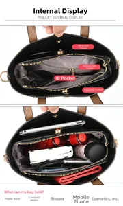Detailed interior of a black leather handbag showing compartments for phones and makeup