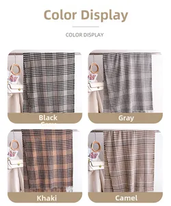 Close-up of houndstooth wool-like scarf in black-grey, grey, khaki and camel shades