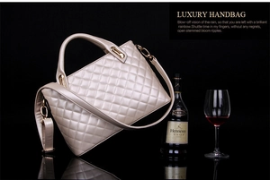 Detail of champagne gold quilted handbag with classic diamond stitching and gold hardware