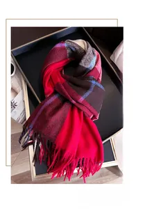 Detail of red and brown plaid scarf with soft fringe edges and high-quality woven texture
