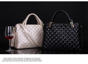 Close-up of quilted pattern and gold hardware on black and beige handbags