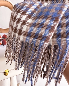 Macro view of blue and brown checkered cashmere-like scarf with long fringe detail
