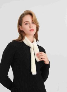 Close-up of plush white faux fur neck warmer scarf showing soft texture on a model