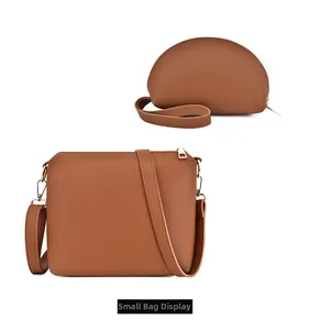Vista dettagliata del set di borse marrone caramello con pochette e cerniera dorata