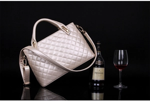 Detail of champagne gold quilted handbag with metallic finish and gold hardware