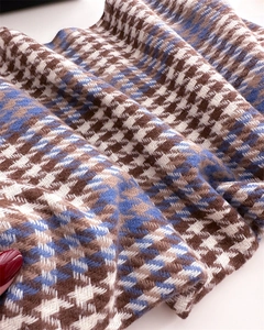 Detail of soft blue and brown houndstooth pattern scarf with brushed cashmere texture
