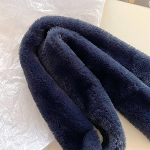Close-up of deep blue faux cashmere scarf showing plush texture and soft material fiber