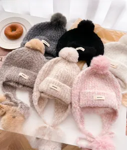 Detailed view of the thick knit texture and soft pom-pom on the winter balaclava hat