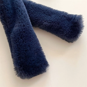 Macro shot of navy blue faux cashmere scarf showing dense, soft fibers and luxury texture