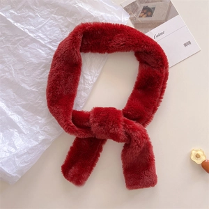 Detail of dark red faux fur scarf showing thick plush texture and stylish cross-knot style