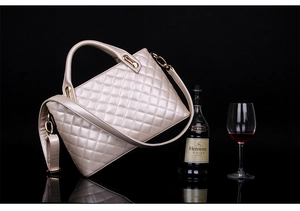 Detailed shot of champagne gold quilted handbag with metallic finish and gold hardware