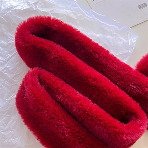 Close-up of bright red faux fur neck warmer showing soft and fluffy texture details