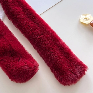 Macro shot of plush dark red faux fur scarf with soft texture and elegant natural shine
